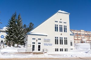 Blue and white exterior of the Finnish American Heritage Center in winter.