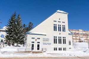 Blue and white exterior of the Finnish American Heritage Center in winter.