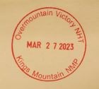 A circular stamp that has Overmountain Victory NMP and Kings Mountain NMP on the outside of the stamp and the date March 23, 2023 in the middle.
