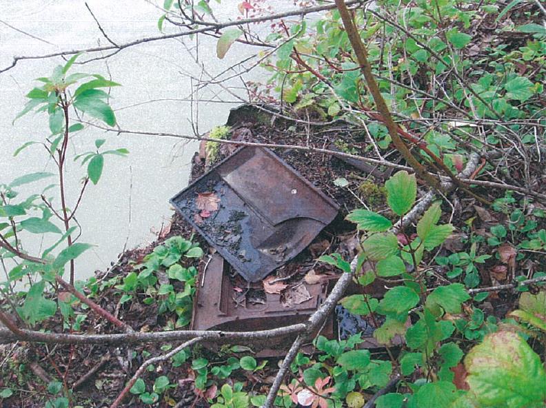 Rusted metal along a river bank Rusted metal along a river bank