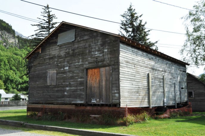 Modern photo of an old wooden building raised above the ground. Modern photo of an old wooden building raised above the ground.