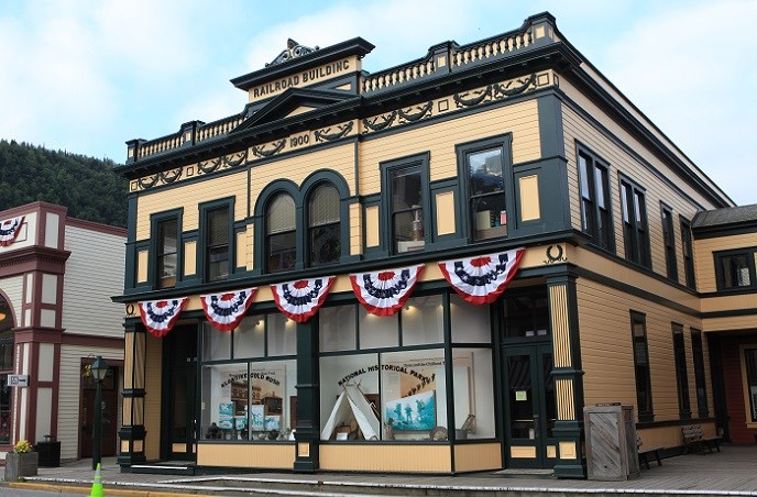 Historic yellow building with green trim decorated with patriotic bunting. Historic yellow building with green trim decorated with patriotic bunting.