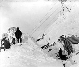 Men standing on deep piles of snow