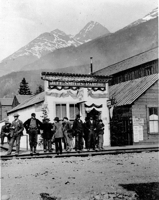 A group of men stand in front of a building