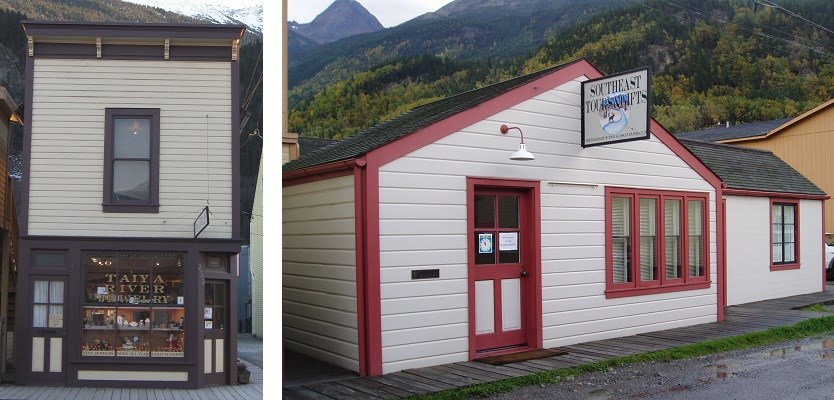 Left: Narrow two story building with window sign reading "Taiya River Jewelry"
Right: Two small single story buildings with red trim