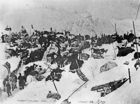 Black and white photo of men and gear in large piles of snow. Black and white photo of men and gear in large piles of snow.