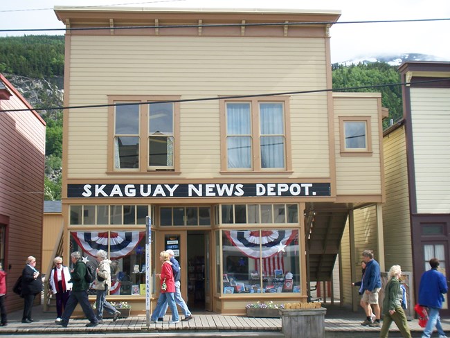 Two story Victorian style building with sign reading "Skaguay News Depot." Two story Victorian style building with sign reading "Skaguay News Depot."