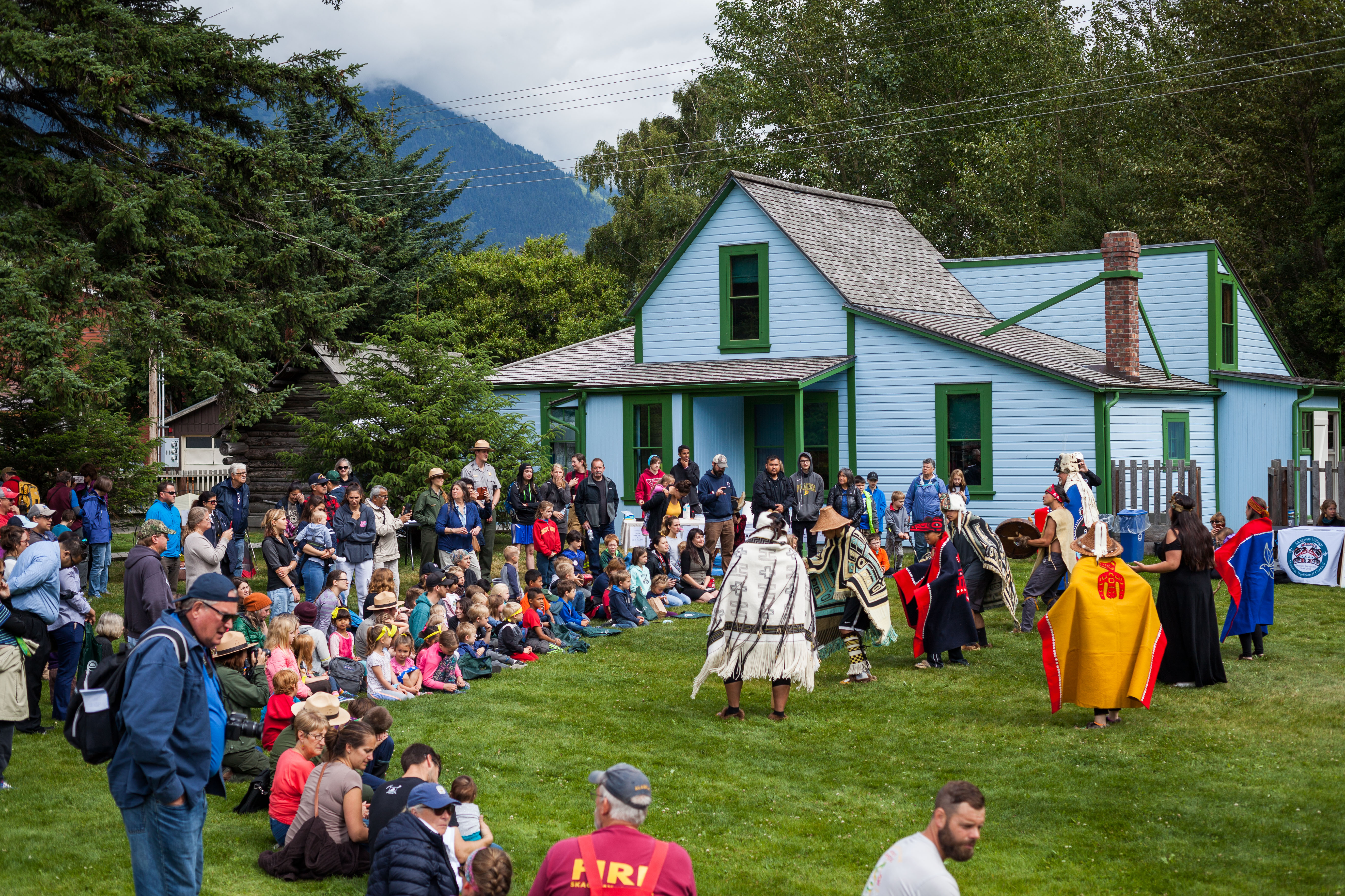 2019 a crowd of people watch Alaska Native traditional dancers