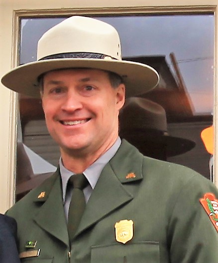 A man in NPS uniform smiles at the camera