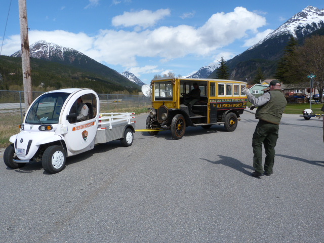 Electric Gem Car towing historic street car in Skagway, AK.