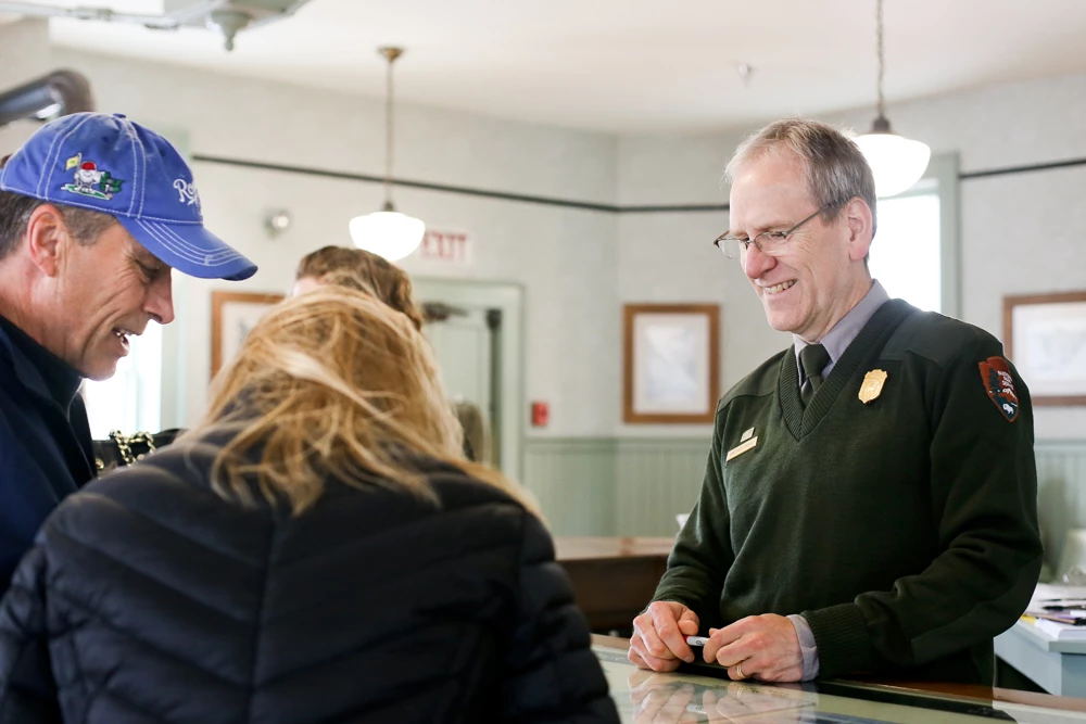 A ranger talks with two people