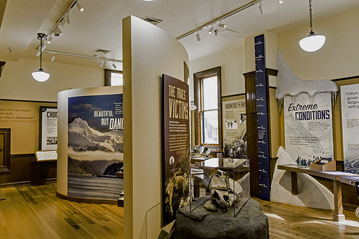 Interior shot of the exhibits within the Visitor Center Museum, with a wall in the center.