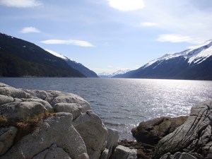 Smoothed rocks in foreground looking toward mountains and ocean