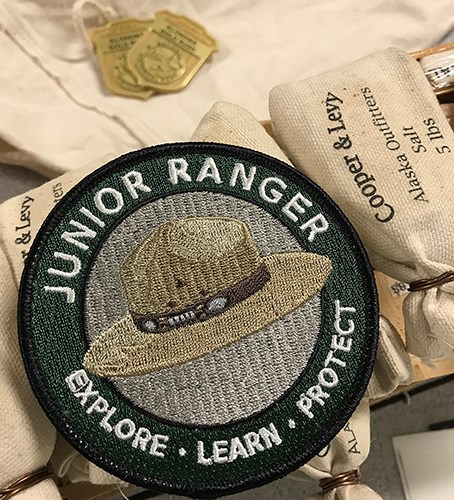 A junior ranger patch on mini sacks of salt