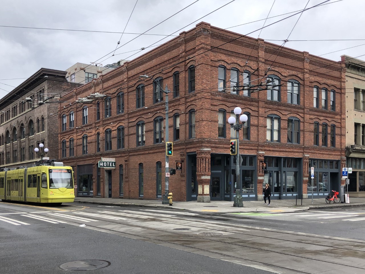 Brick building with glass windows on street corner.