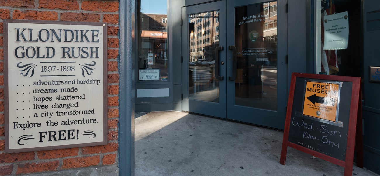 Two blue exterior doors of a brick building.