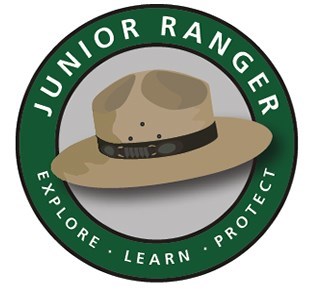 Logo of a ranger flat hat with the words "Junior Ranger. Explore. Learn. Protect."