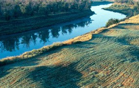 Sakakawea village site along the Knife River.  Notice earthlodge impression along grass river banks.