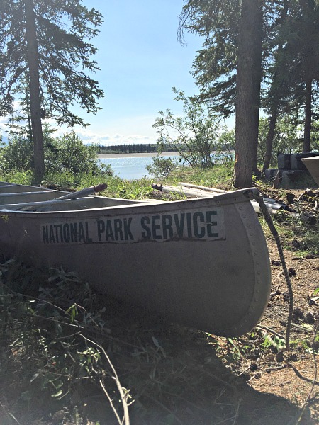 Canoe with National Park Service written on it with river in the background