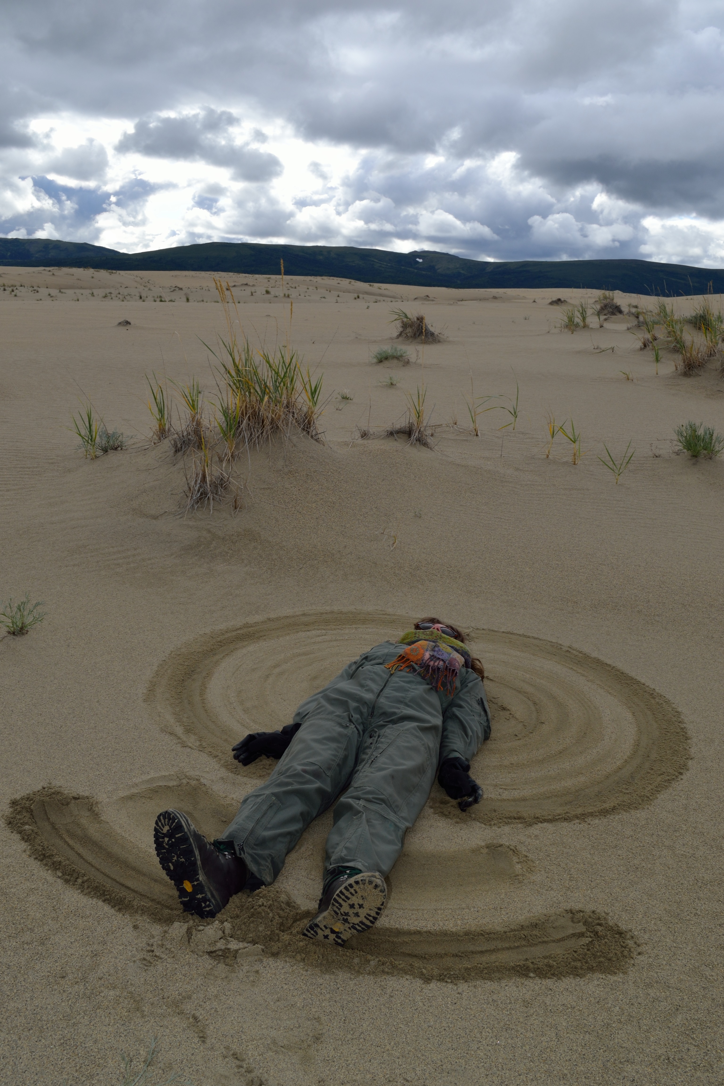 Ranger Thea creates a “sand angel” in the dune. Photo by NPS/Rachel Post.