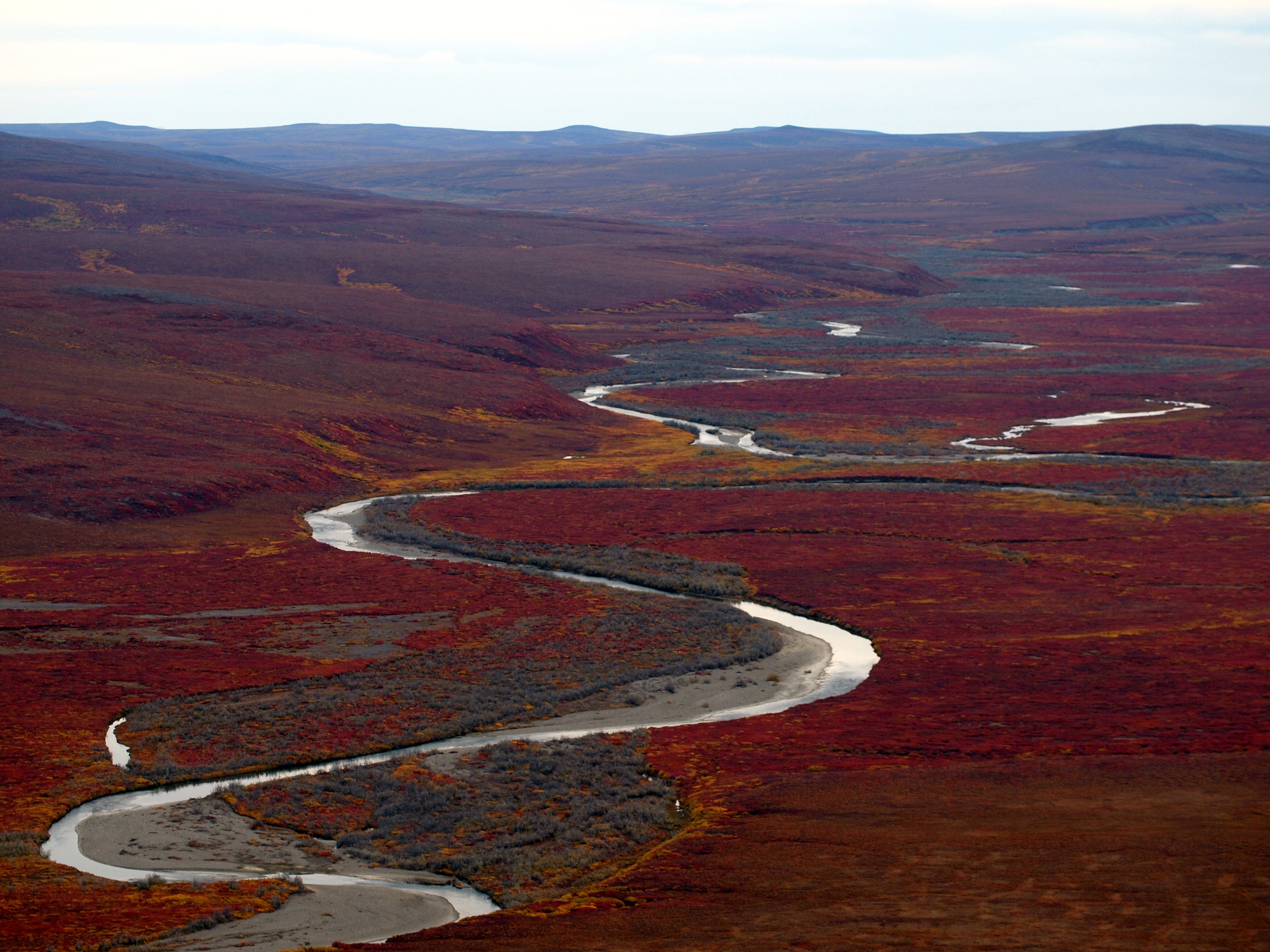 A remote river surrounded by autumn colors.