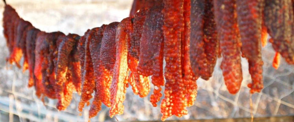 red fish eggs drying on a rack