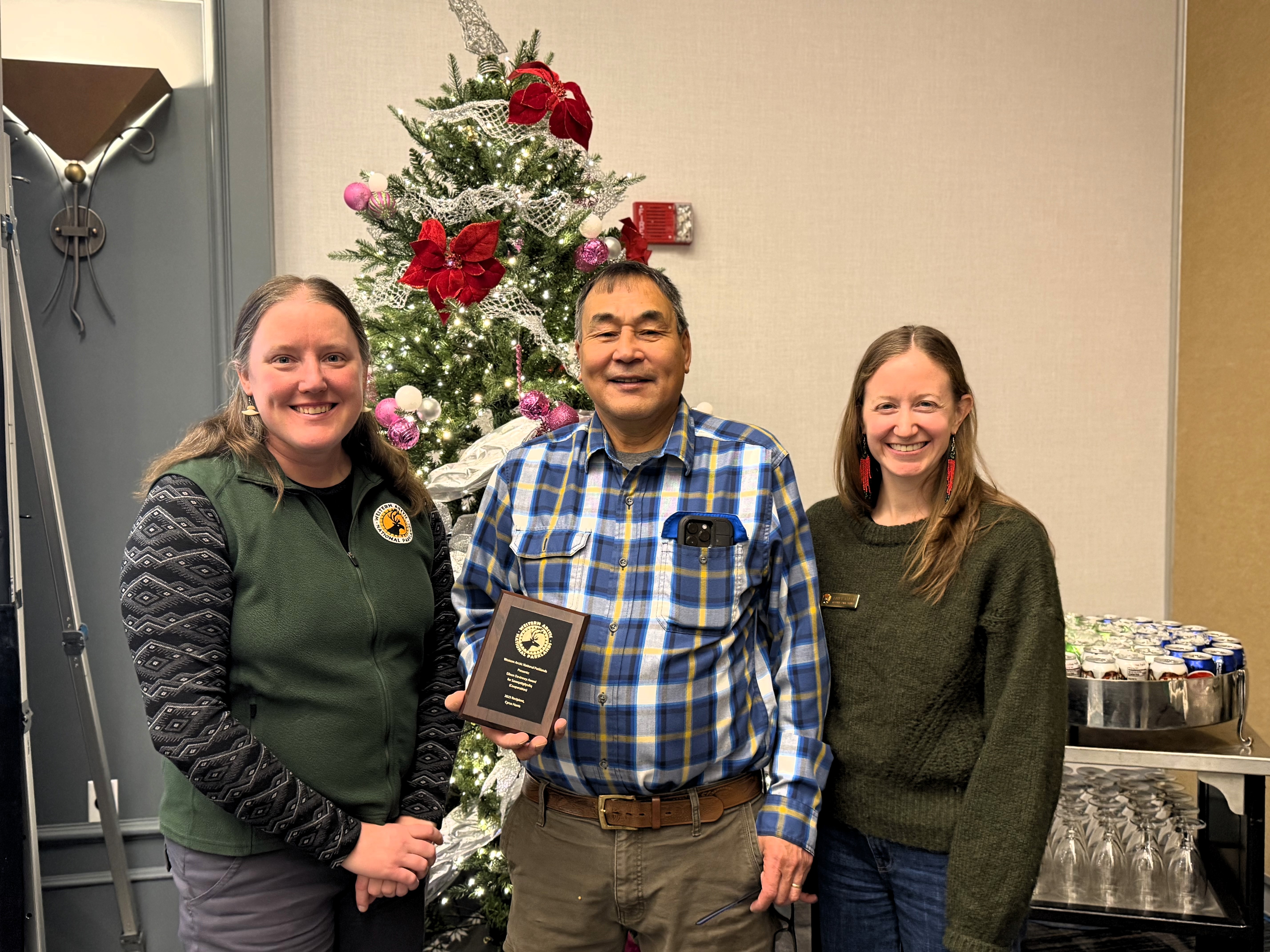 Cyrus Harris receives the Eileen Devinny award from Emily Creek and Ann Carlson