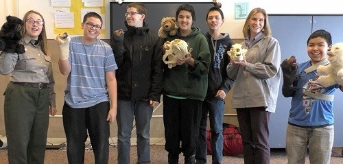 Students from "The Ranger Report" pose with bear puppets and skulls