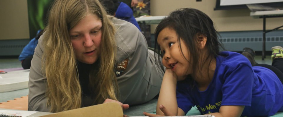 A woman instructing a girl on vocabulary.^[[Image](https://www.nps.gov/kova/planyourvisit/kids-programs.htm) by the [U.S. Department of the Interior](https://www.doi.gov/) is in the public domain]