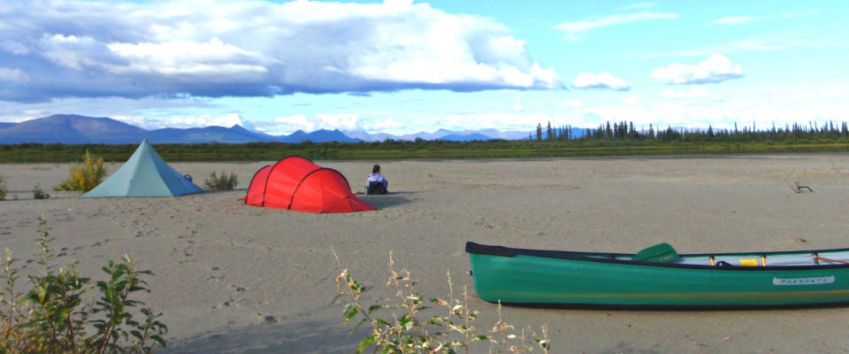 tent and canoe on sand