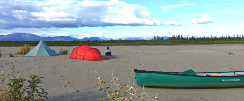 tent and canoe on sand tent and canoe on sand
