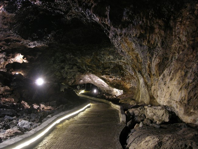 A lighted paved walkway in Mushpot cave.