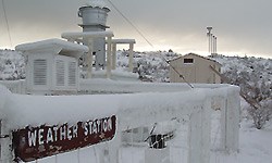 A weather station blanketed with snow