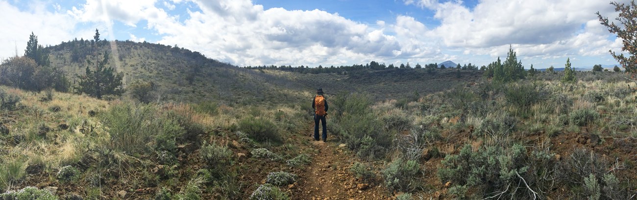 Hiker walking along the Whitney Butte Trail