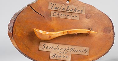 A plaque with a wooden spoon from Richard Proenneke's cabin.