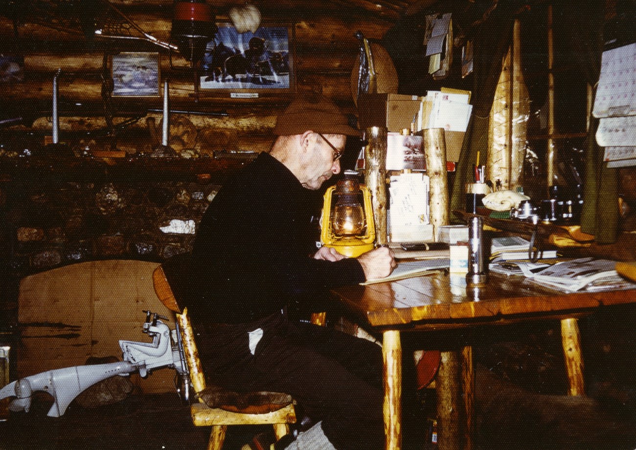 a man sitting at a desk writing