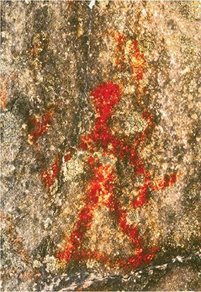 A red ochre pictograph of a human figure, with legs, somewhat relaxed, joined by a thin line, holds what appears to be two rattles.