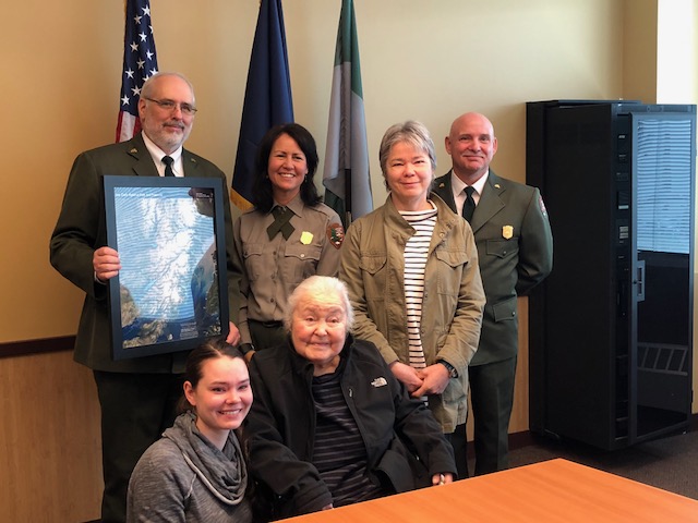 Family members Bella Hammond, Heidi Hammond, and Lauren Stanford gather with NPS Alaska Regional Director Bert Frost, Deputy Regional Director Joel Hard, and Lake Clark National Park Superintendent Susanne Fleek-Green to celebrate the dedication