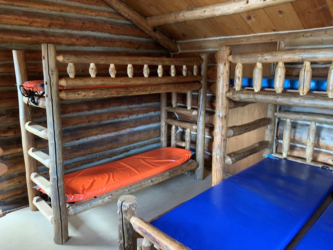 Wooden bunk beds inside a wooden cabin