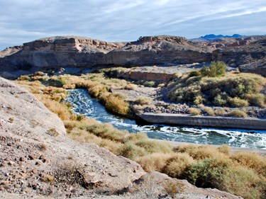 Wash runns through canyons with foliage beside it