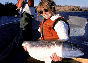 Fisherwoman holding a Striped Bass