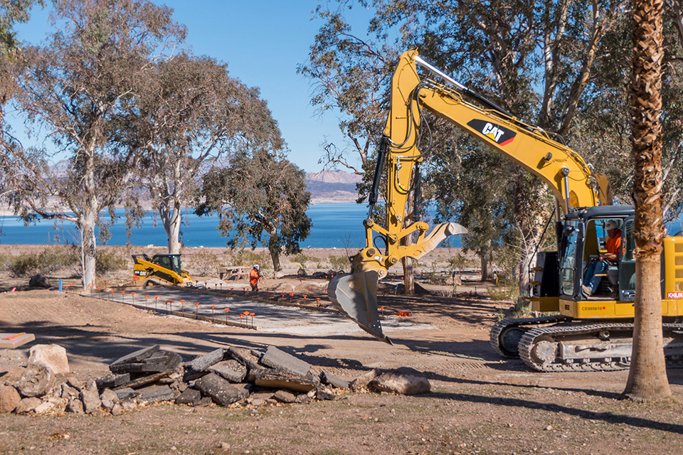 Large backhoe works to improve camping pad at Boulder Beach Campground