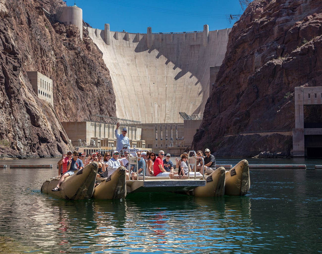 visitors on raft by Hoover Dam