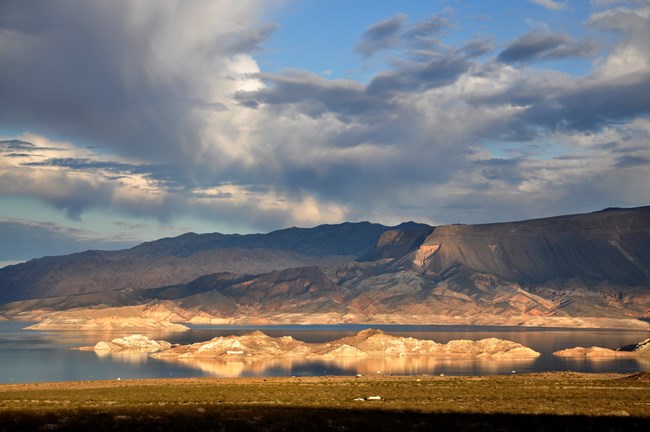 A landscape photo with a lake and mountains.