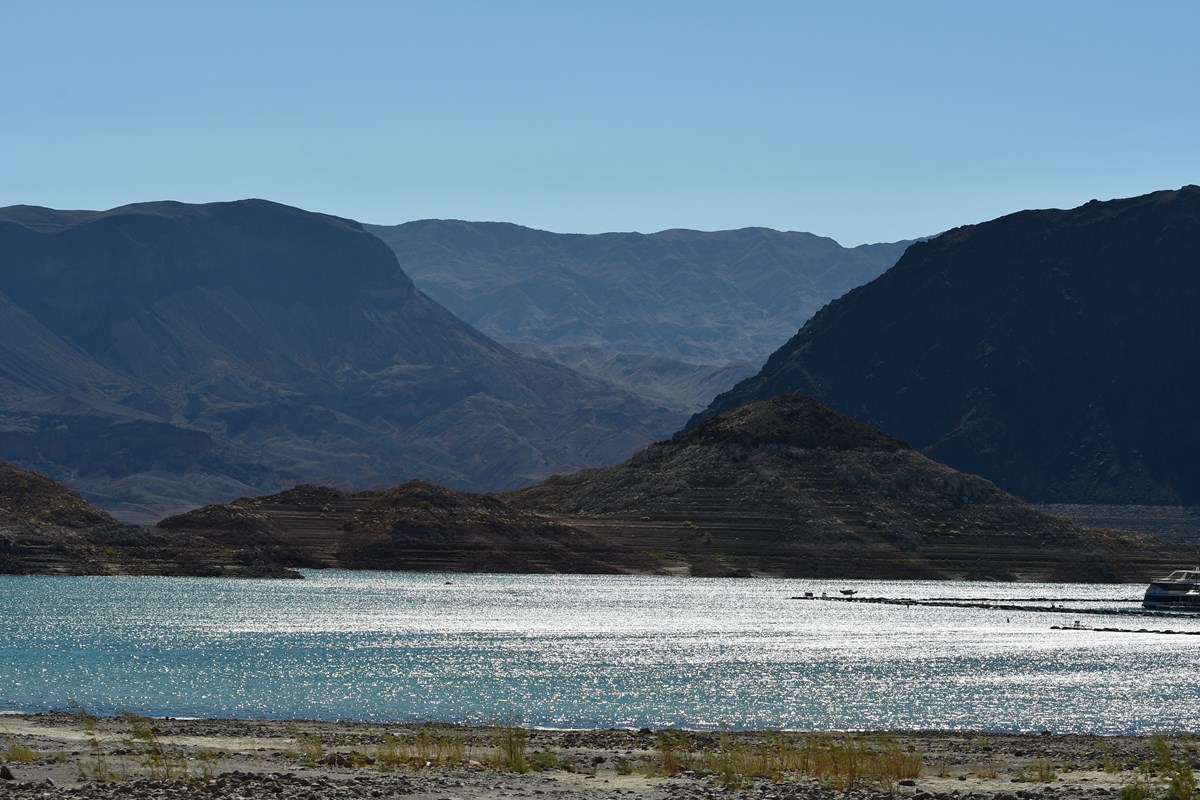 Lake Mead with light reflecting on the water and mountains in the background