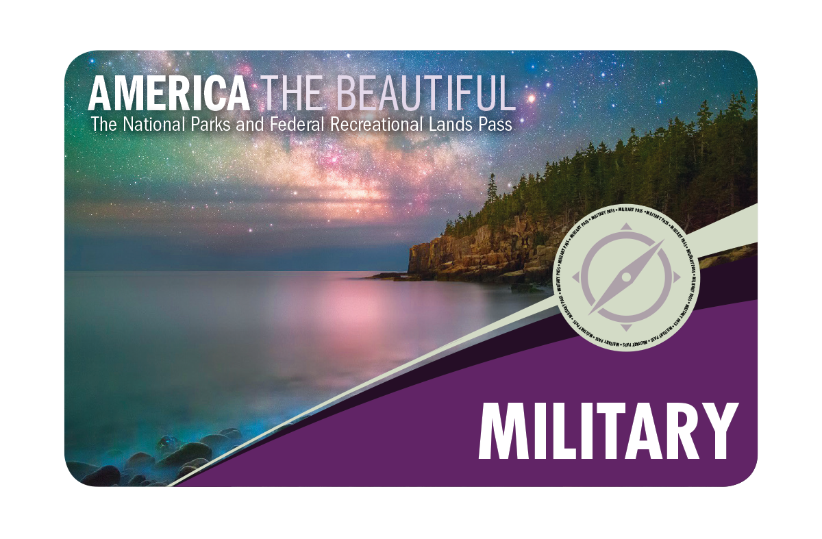 The aurora is reflected in calm lake water.