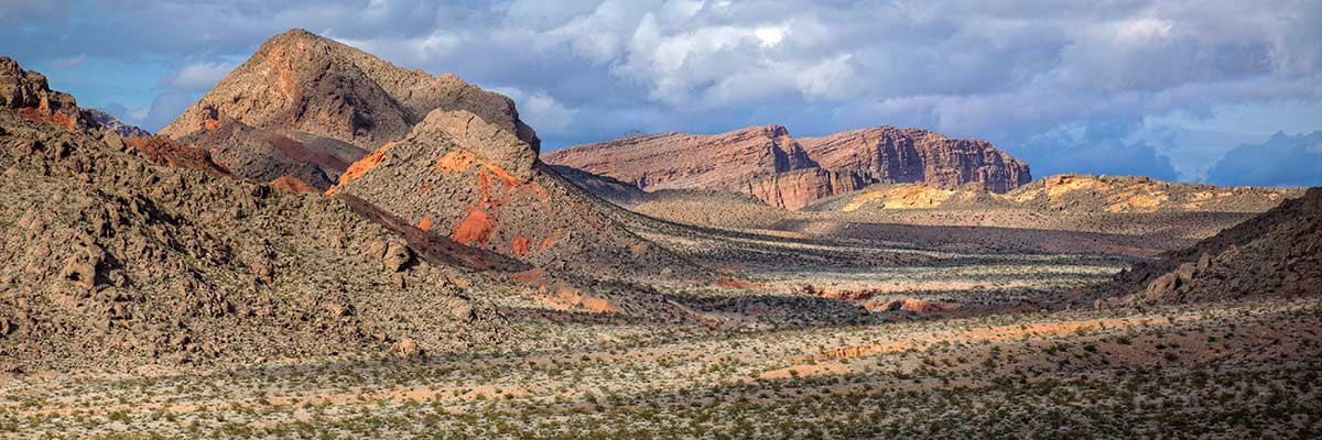 Rugged red hills and mountains among desert scrub