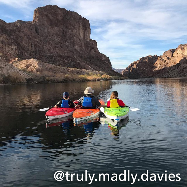 three kayaks resting along the river in the canyon