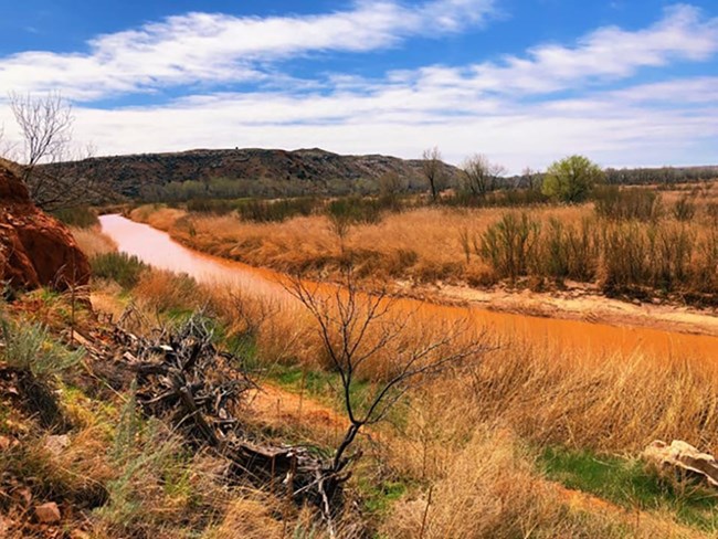 Canadian River flowing on a sunny day with blue skies.