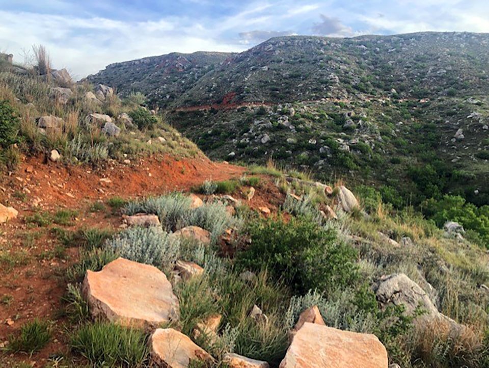 Fritch Fortress Trail with green sage on a sunny day with blue skies